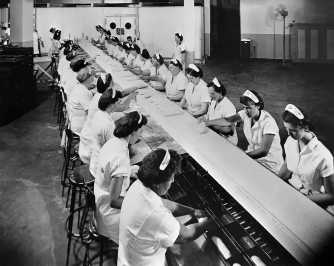 High angle view of a group of female workers working in a bread factory