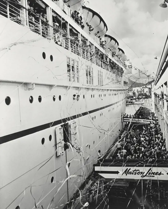 Vintage photograph. View of the arrival of the SS Lurline at the pier in Honolulu. Matson liner arrives amidst an atmosphere of gaiety and revelry