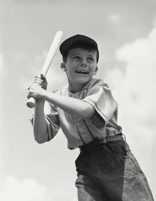 Vintage photograph. Young boy with baseball bat waiting for pitch
