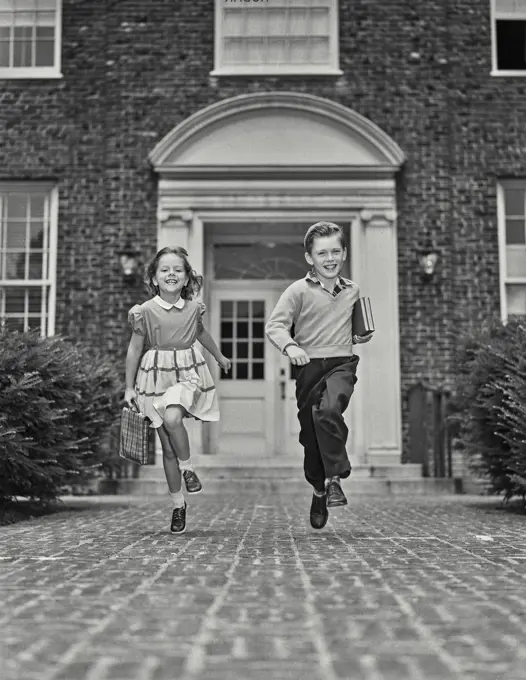 Vintage Photograph. Young boy and girl walking down path with school supplies. Frame 8
