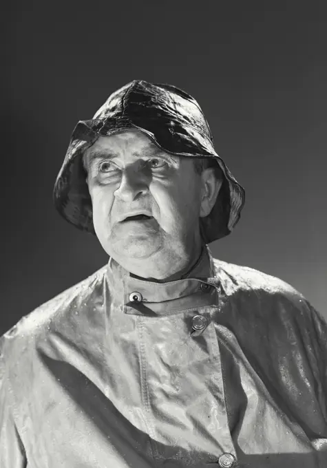 Vintage photograph. Man in rain hat and rain coat