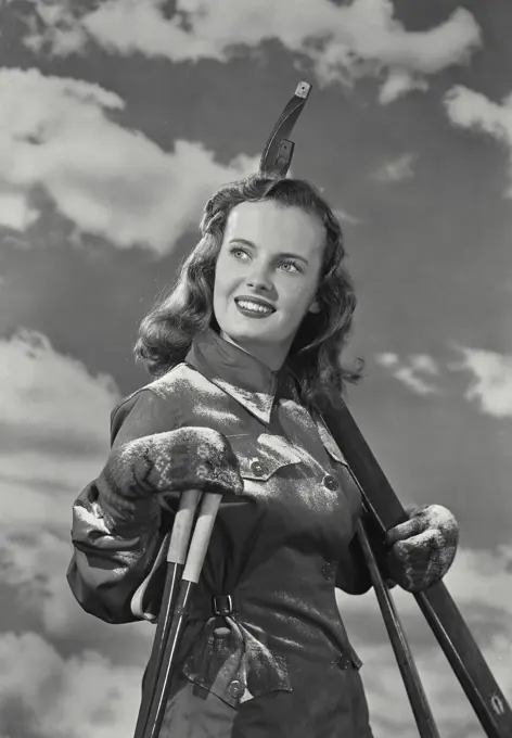 Vintage Photograph. Side profile of a young woman holding a ski