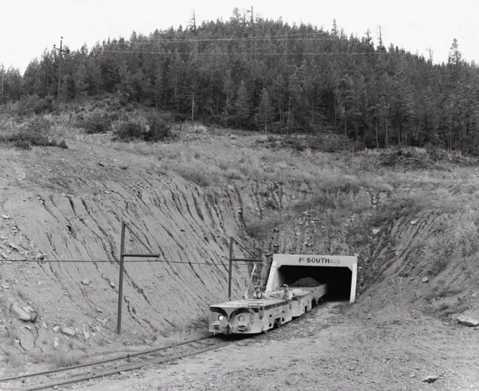 Train coming out from a tunnel of an iron mine, Colorado, USA