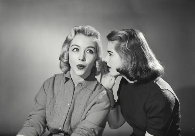 Vintage Photograph. Two women telling secrets. Frame 2
