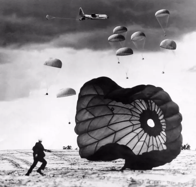 Paratroopers parachuting from a military airplane