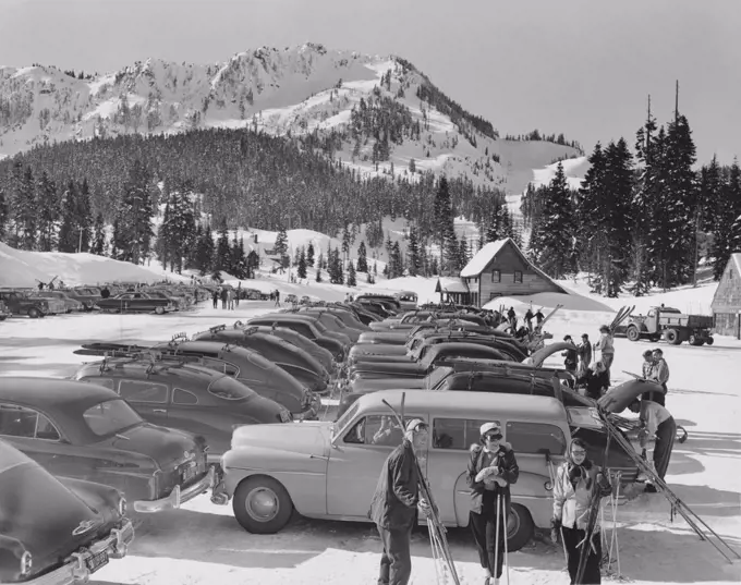 Tourists standing near parked cars in a parking lot, Cross State Highway, Stevens Pass, Washington, USA