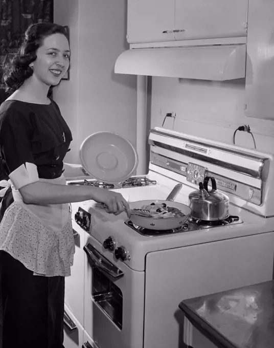 Young woman preparing meal in kitchen