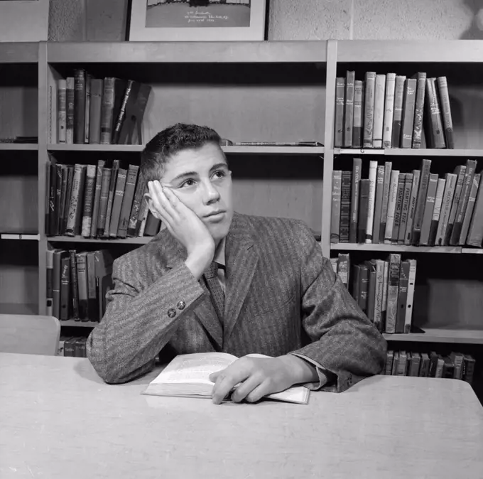 School boy reading in library