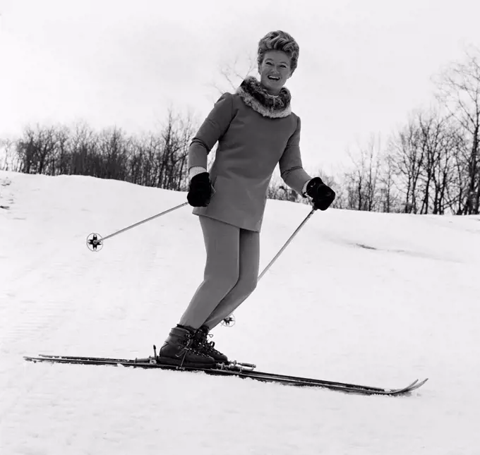 Elegant woman smiling and skiing