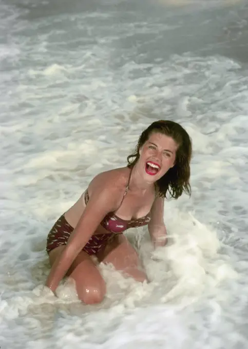 Mid adult woman bathing in sea