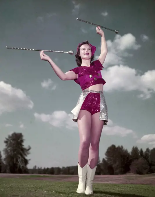 Low angle view of majorette twirling baton