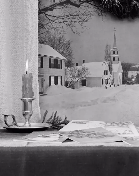 USA, Vermont, Waterford, Christmas candle and greeting cards on window sill, church in background