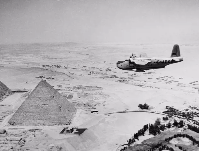 Egypt, Giza, Aeroplane flying over Giza Pyramids