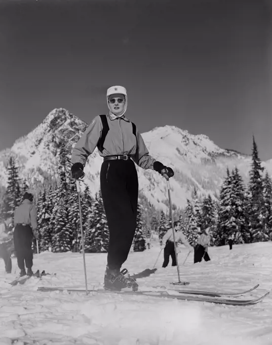 Ski Patrol woman with snowcapped mountains in background