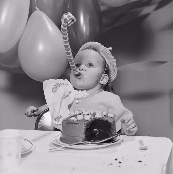 Baby girl with birthday cake
