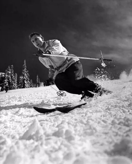 Low angle view of a young man skiing downhill