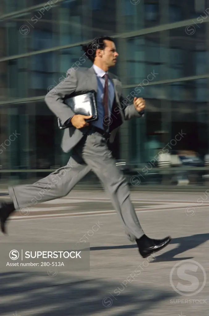 Businessman running with a portfolio