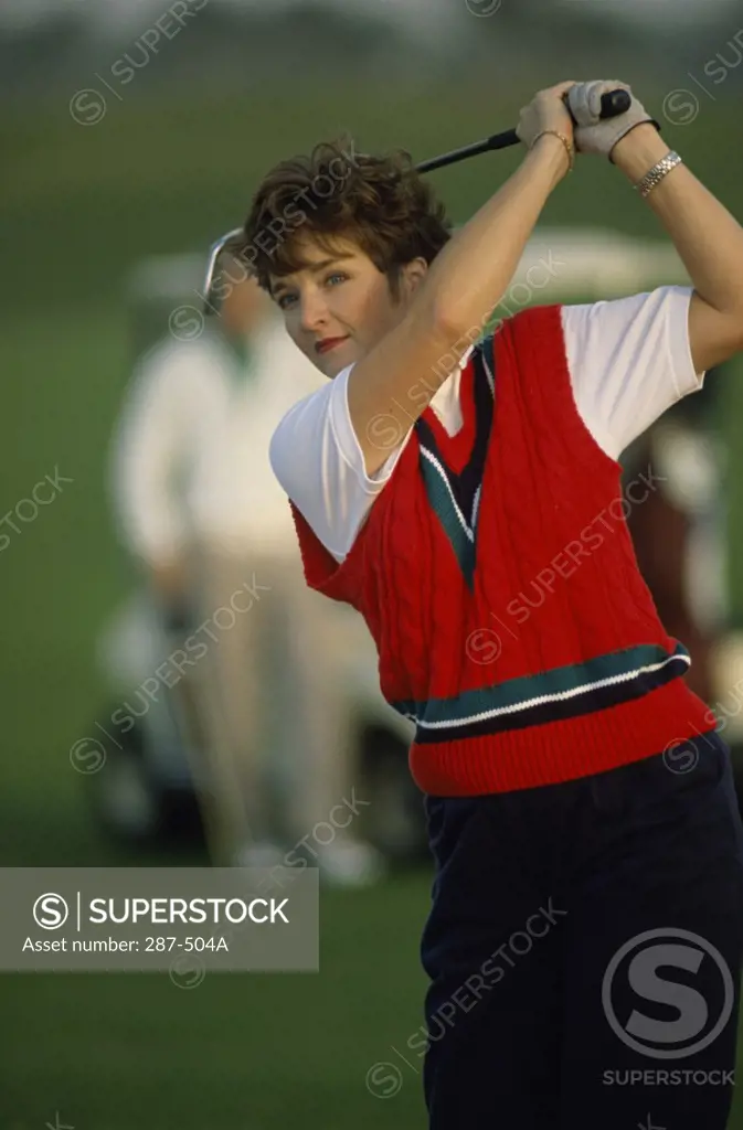 Mid adult woman playing golf