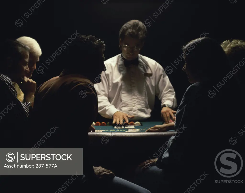 Group of people playing blackjack in a casino