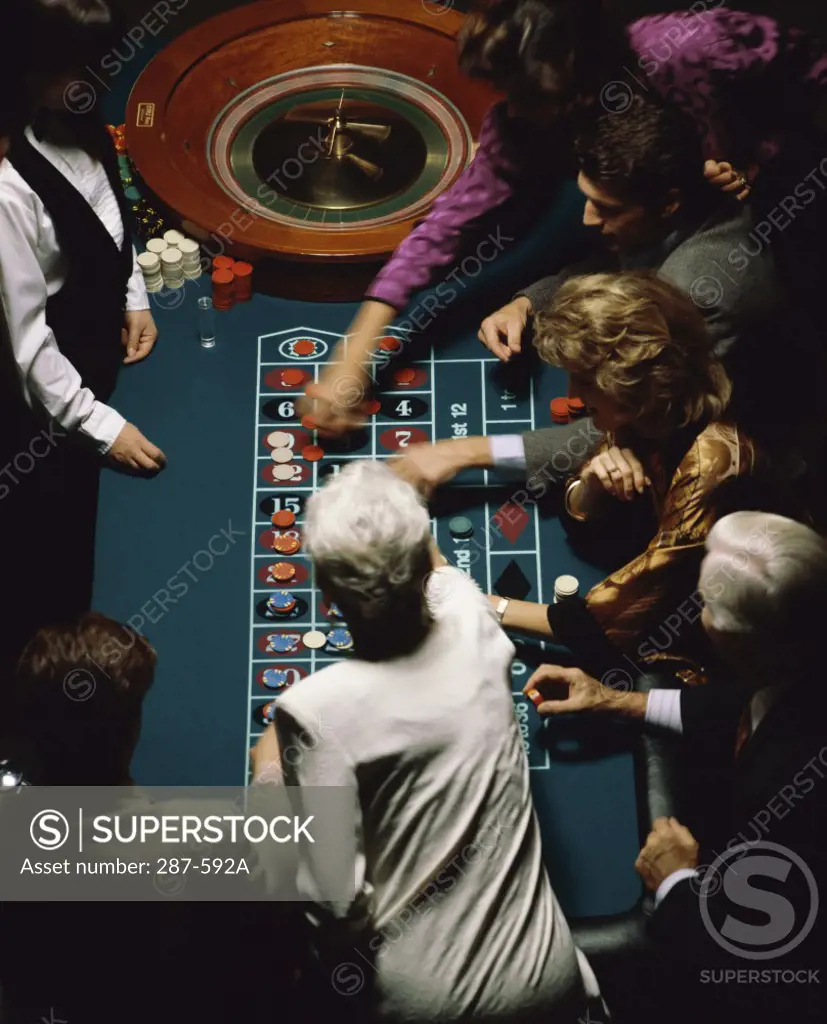 High angle view of a group of people at a roulette table