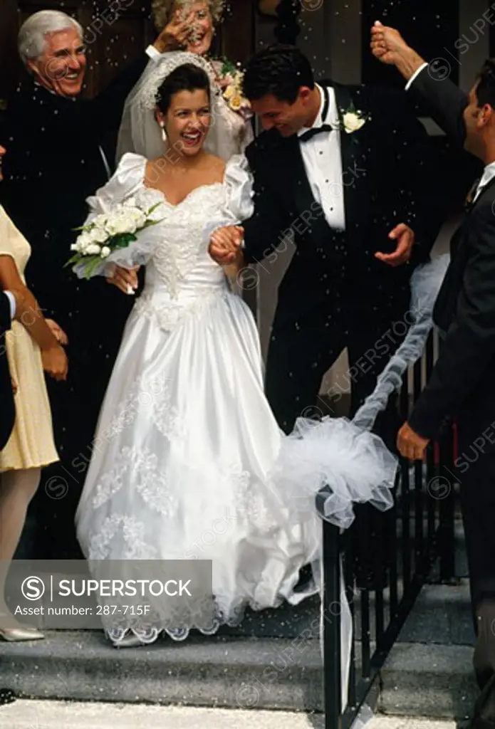 Bride and groom smiling with holding hands