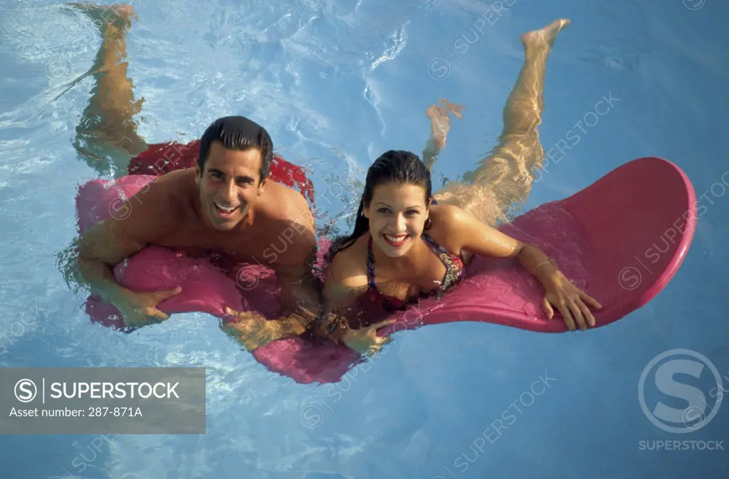 High angle view of a young couple swimming in a swimming pool