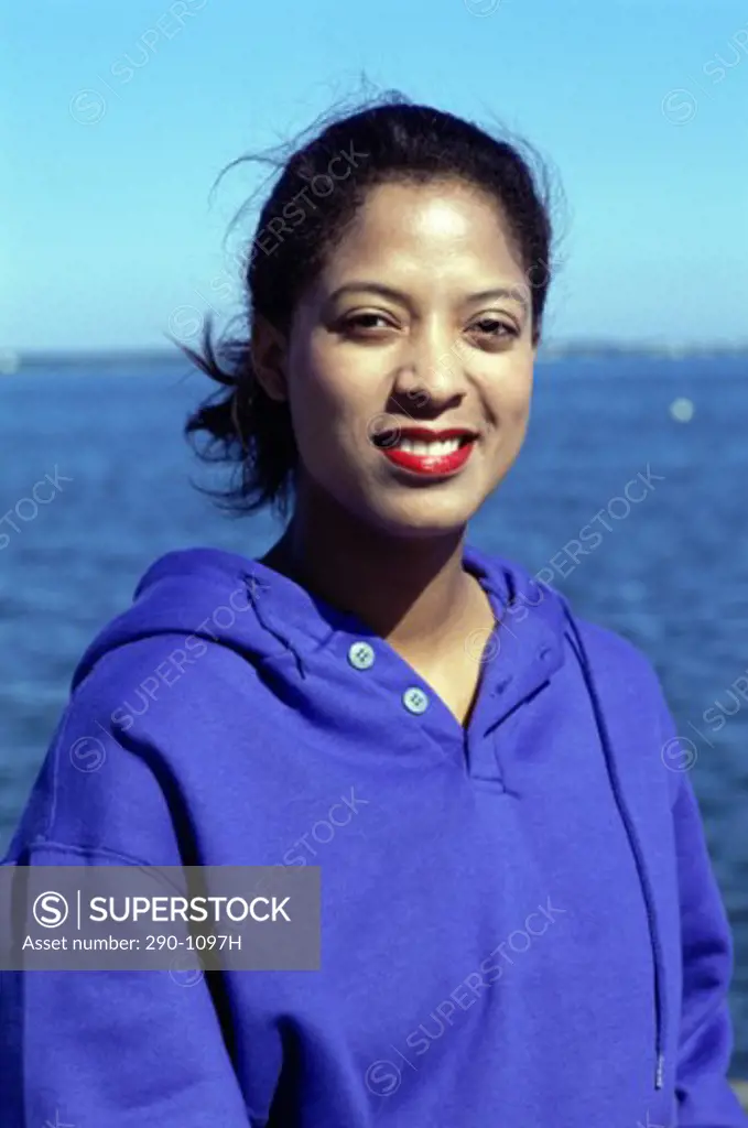 Portrait of a young woman smiling on the beach