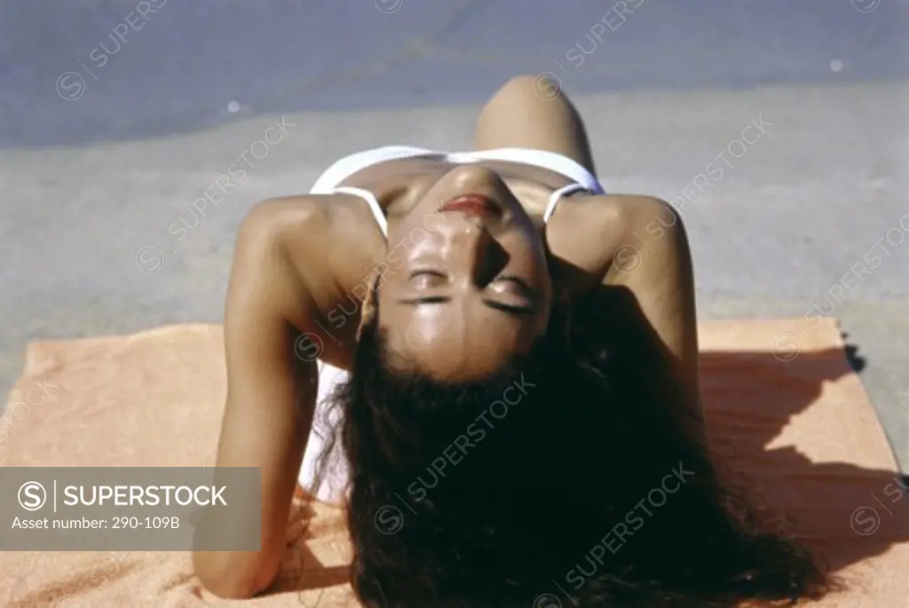 Young woman sunbathing on the beach