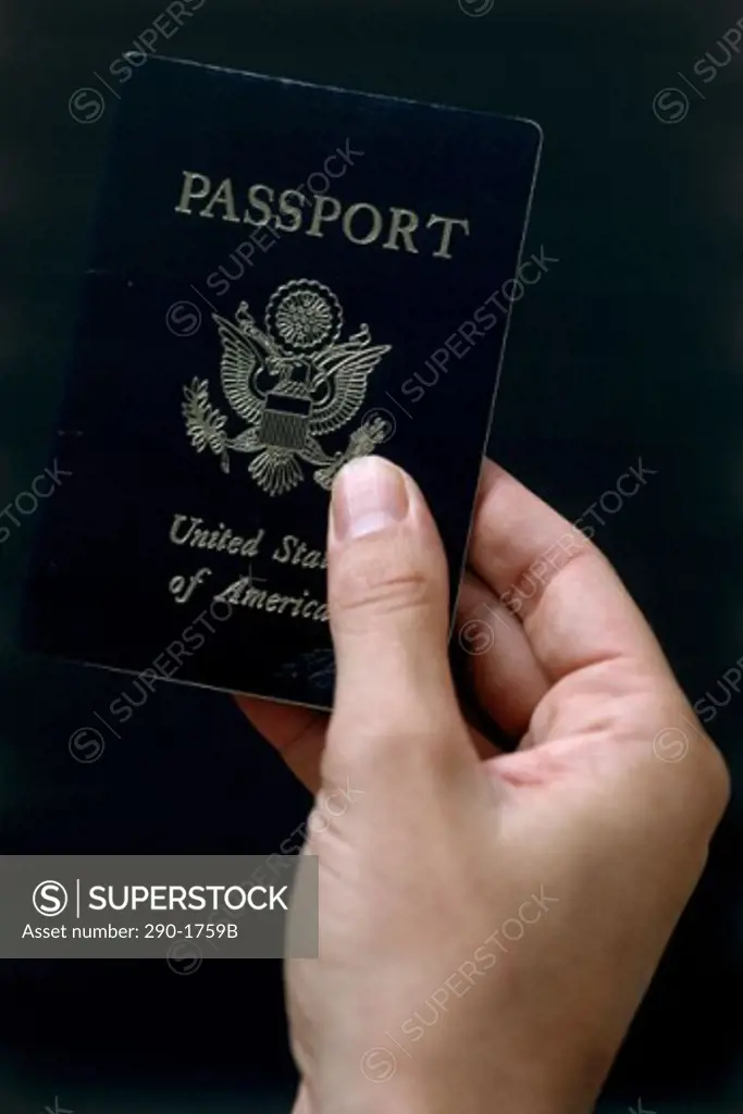 Close-up of a person's hand holding a passport
