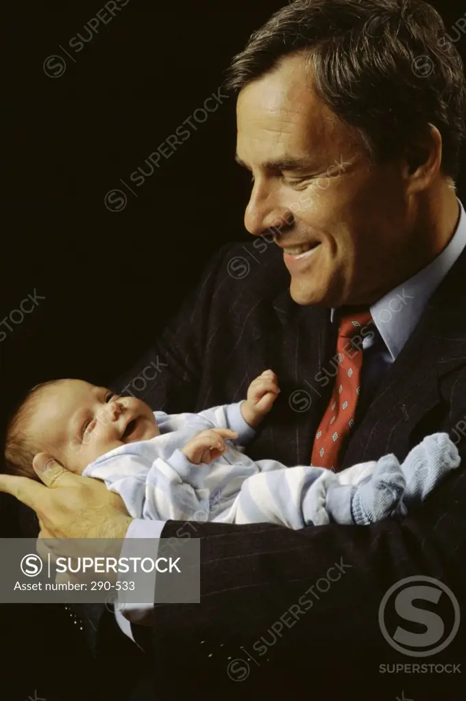 Close-up of a mature man holding his son