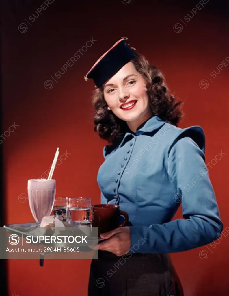 Waitress holding a tray and smiling