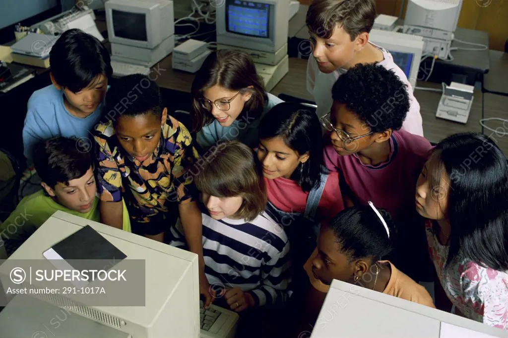 High angle view of a group of children in a classroom in front of a computer