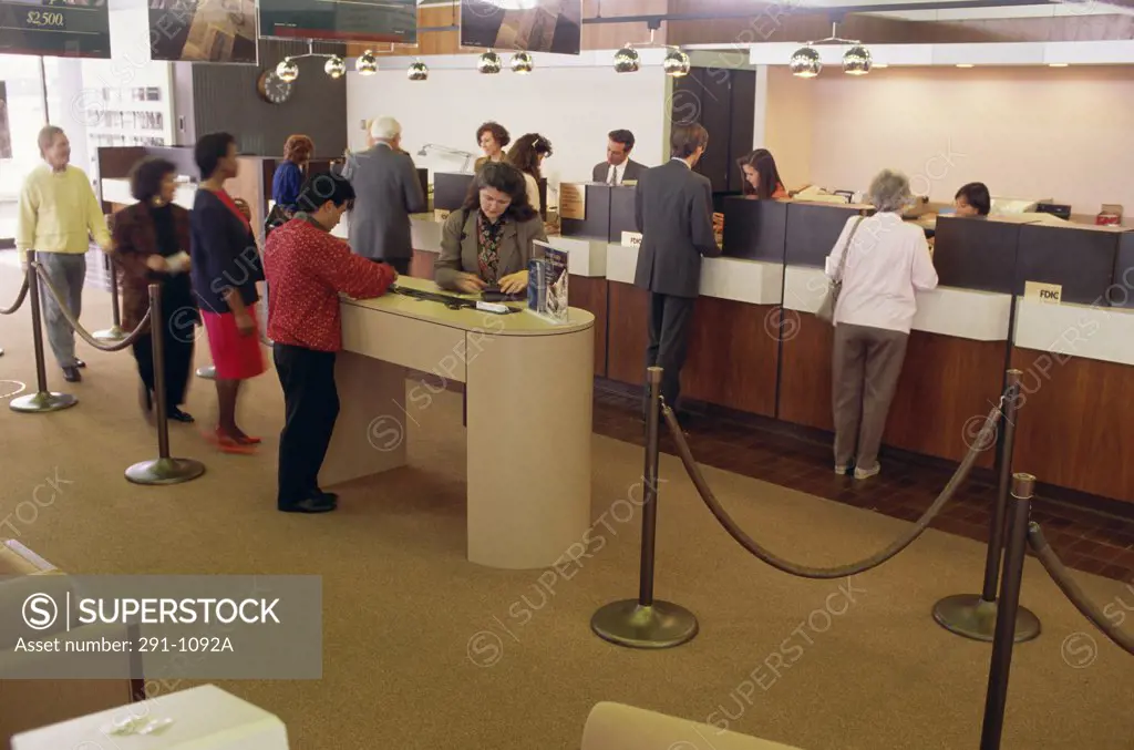 Bank employees with customers in a bank