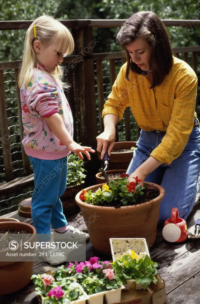 Mid adult woman gardening with her daughter