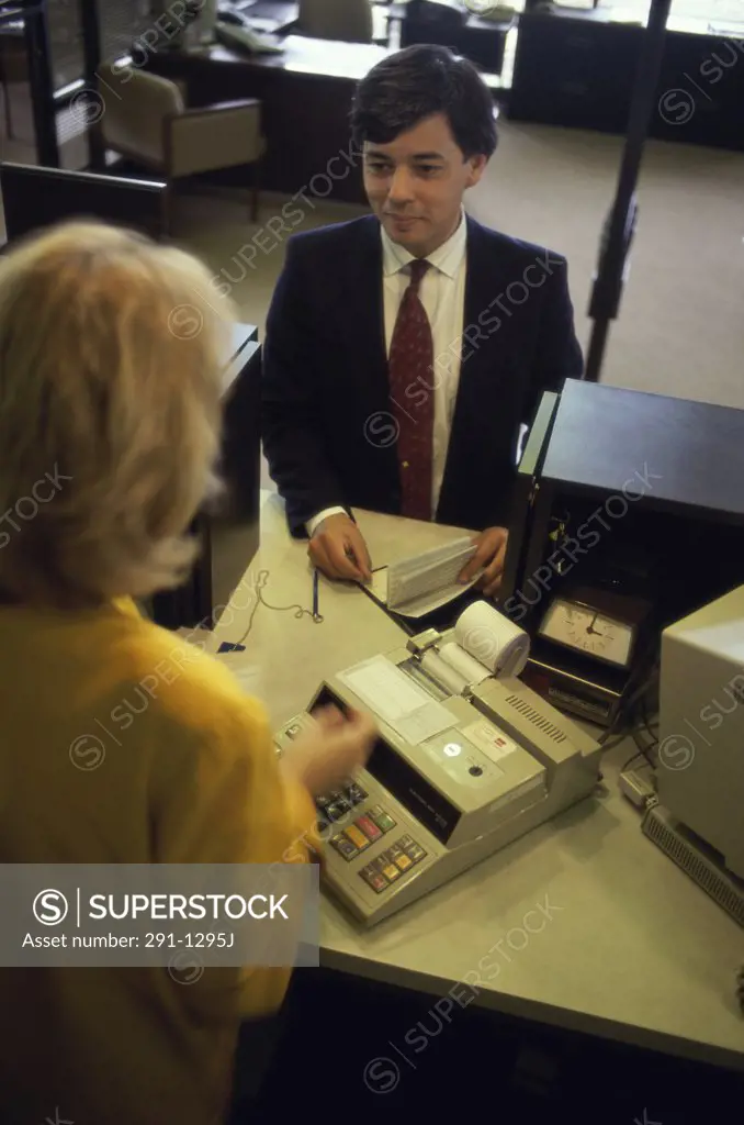 Bank teller assisting a customer in a bank
