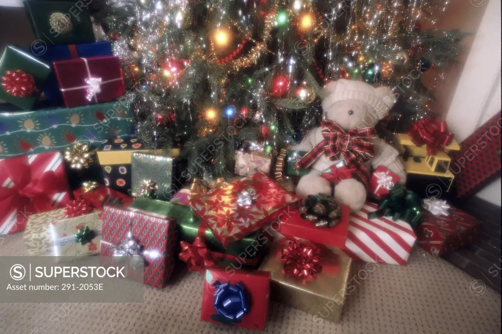 Close-up of Christmas presents with a Christmas tree