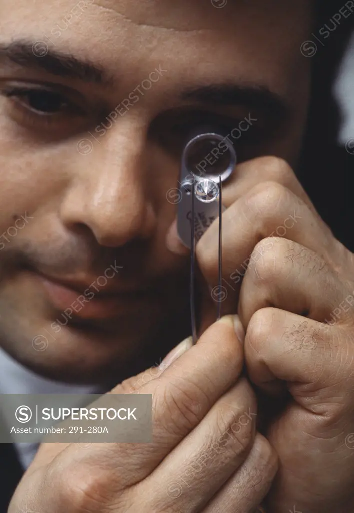 Close-up of a jeweller examining a diamond