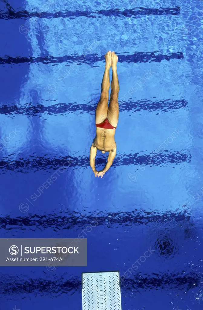 High angle view of a man diving into a swimming pool