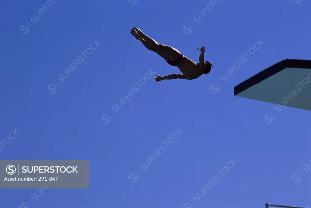 Low angle view of a man diving from a diving board
