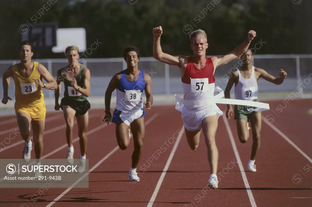 Male athletes running on a running track
