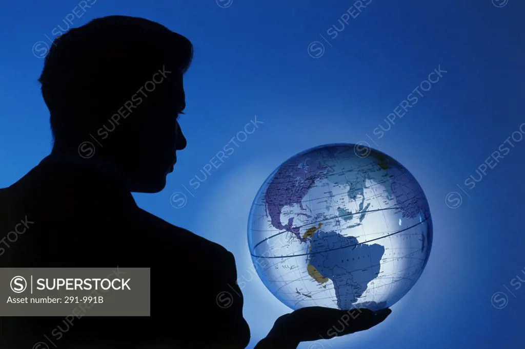Silhouette of a businessman holding a globe