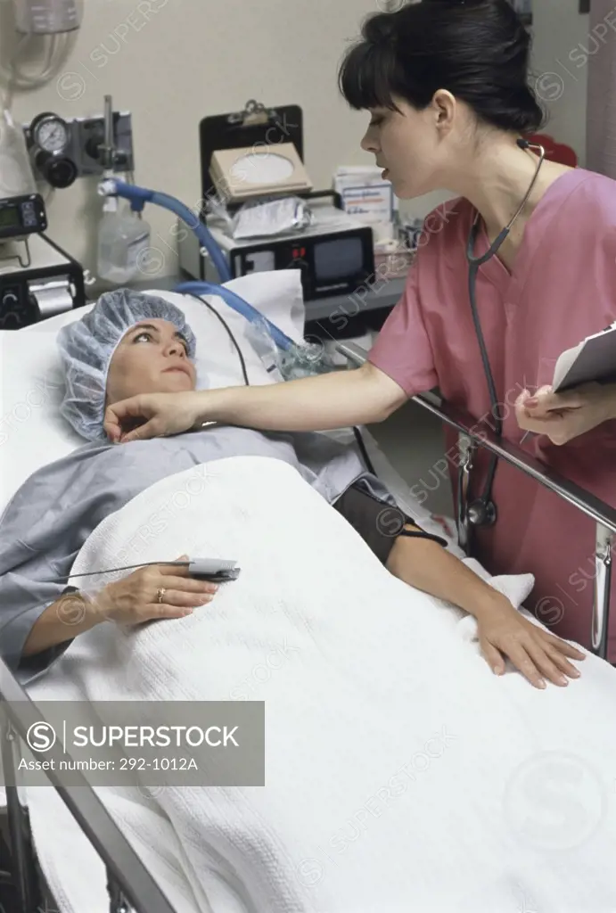 Female doctor examining a patient in a hospital room