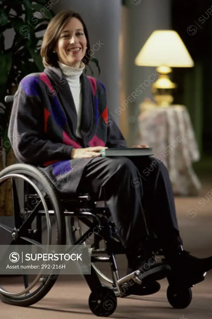 Young woman sitting in a wheelchair and smiling