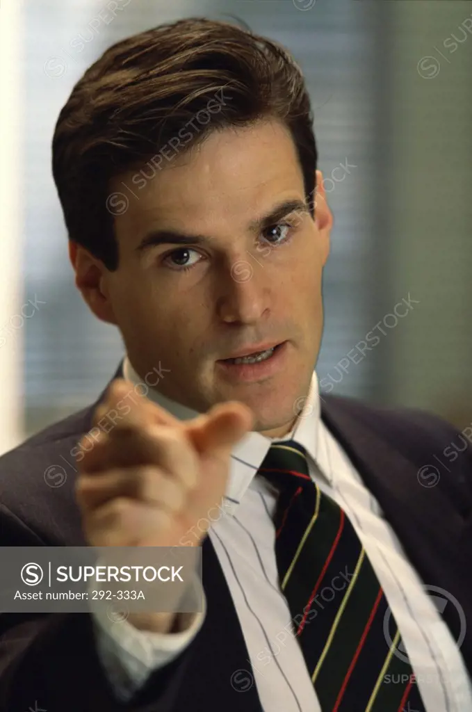 Portrait of a businessman pointing forward