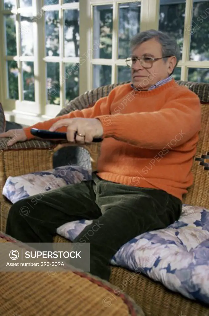 Senior man holding a remote control