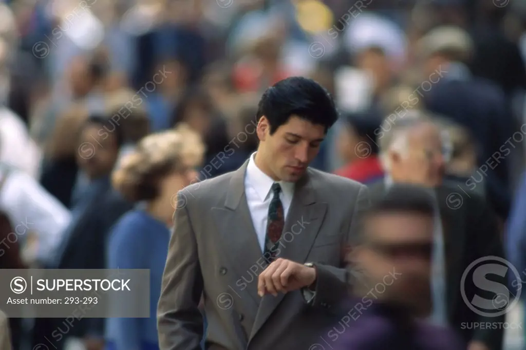 Businessman checking the time on his wristwatch