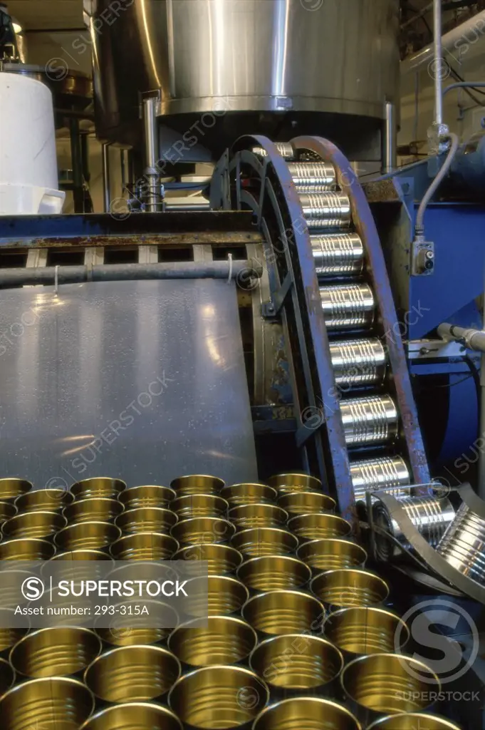 Cans on a conveyor belt in food processing plant