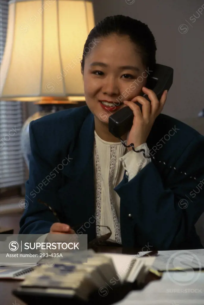 Businesswoman talking on the telephone smiling