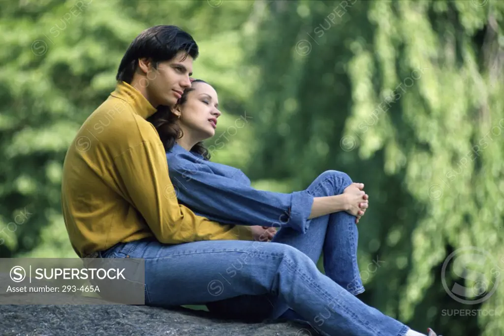 Young couple sitting on a rock