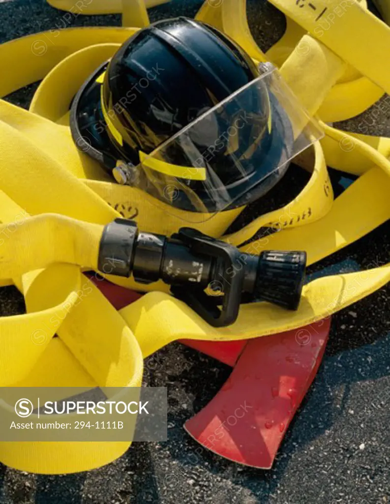 Close-up of a firefighter's helmet on a fire hose